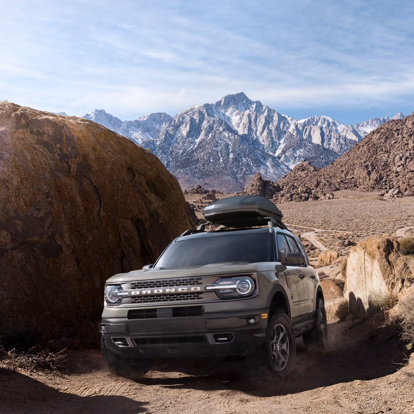 Ford Magnitude Super C motorhome driving on an open desert highway under a clear blue sky.