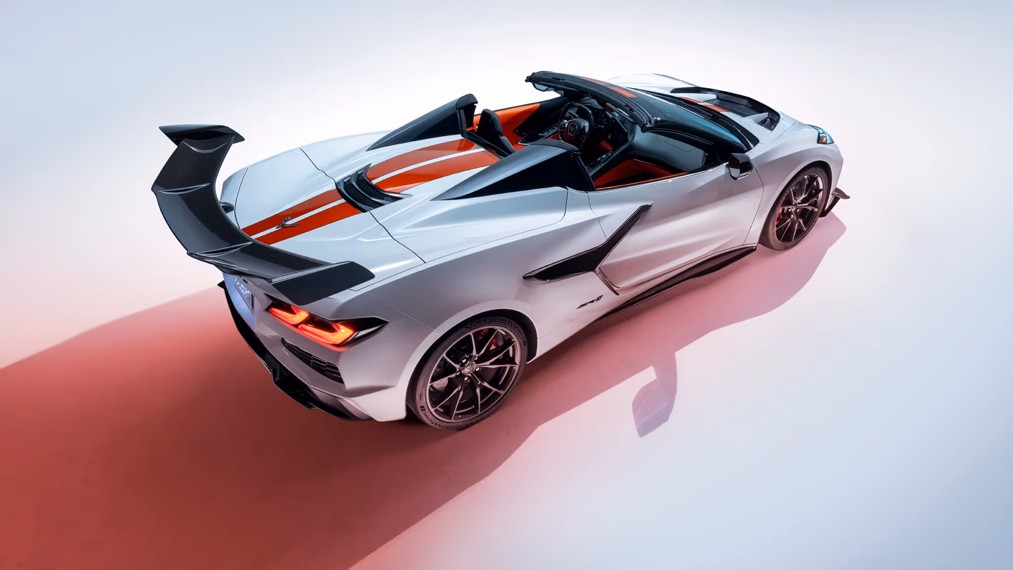 Three-quarter rear shot of the Corvette ZR1 with accent lighting on taillights and rear wing structure.