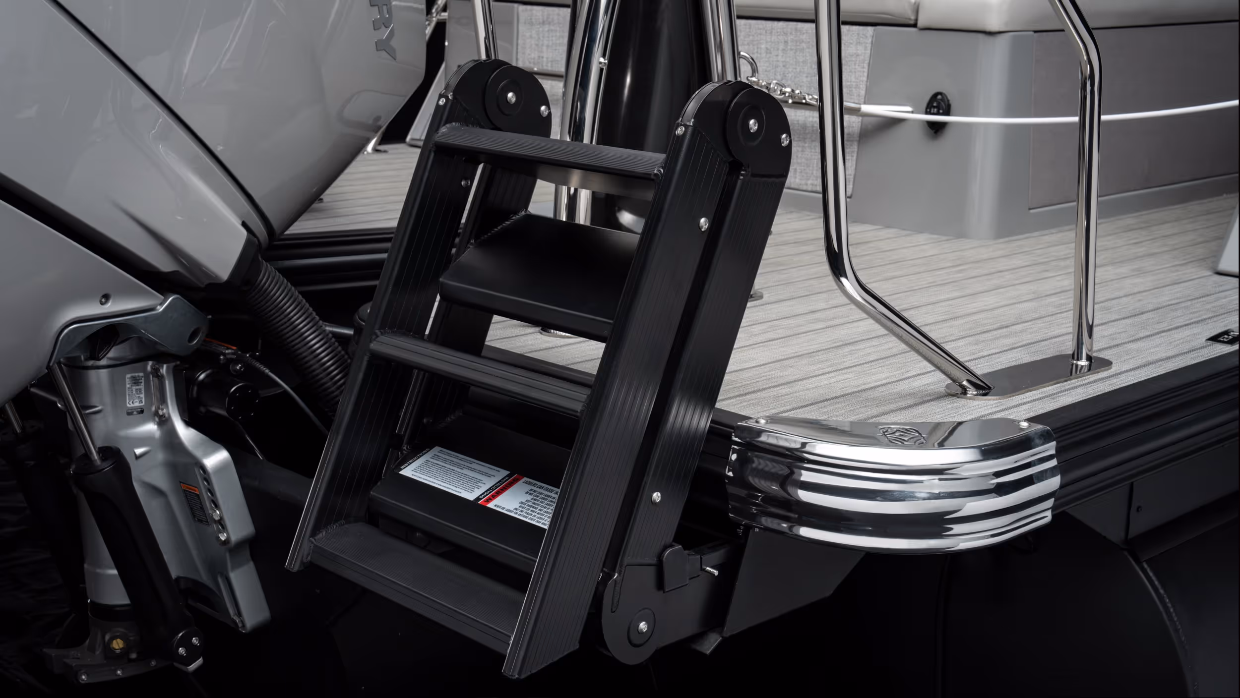 Close-up of rear boarding ladder and deck materials showing craftsmanship and hardware detail.