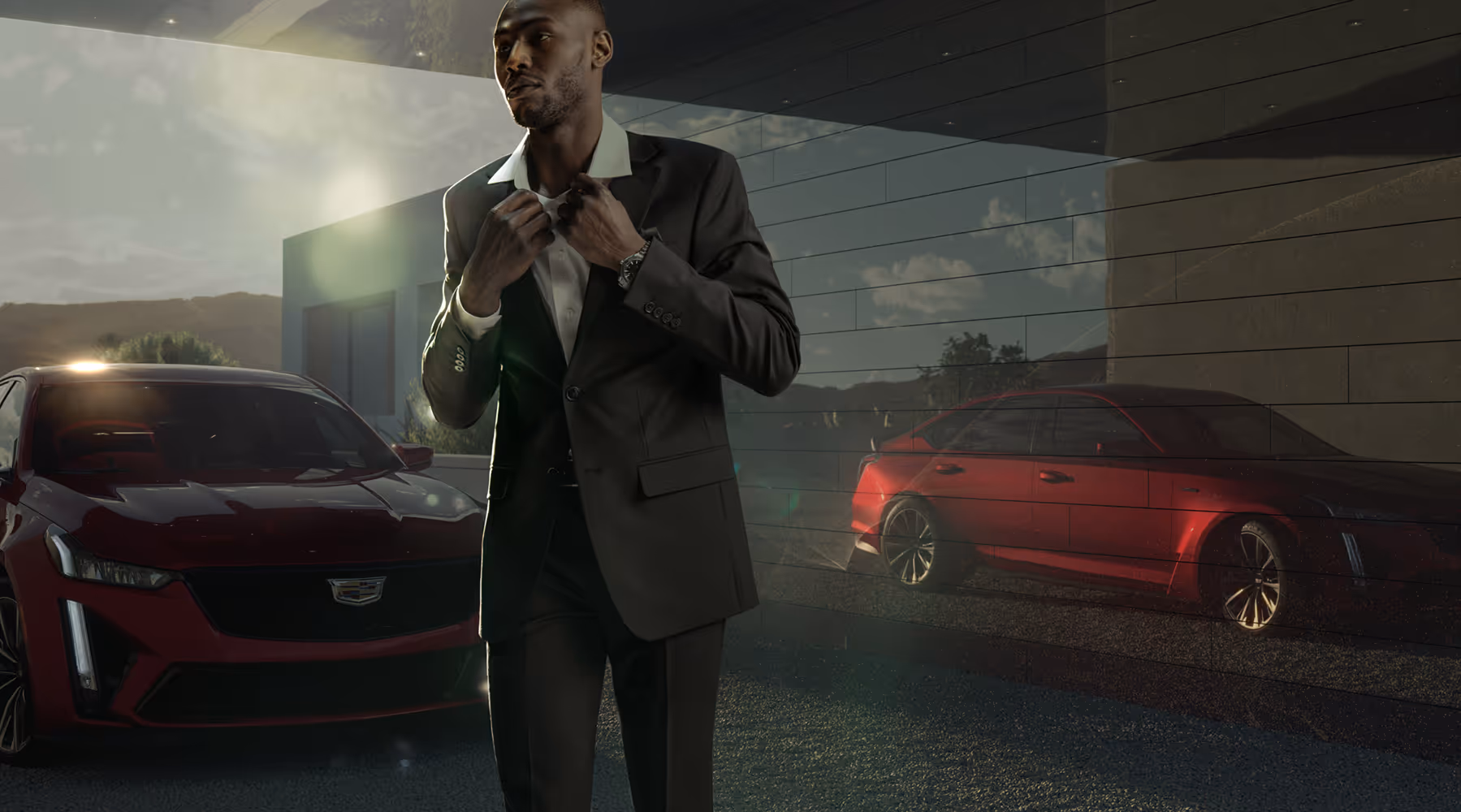 Man in tailored suit adjusting jacket in front of a red Cadillac CT5 parked by a modern home at sunset.