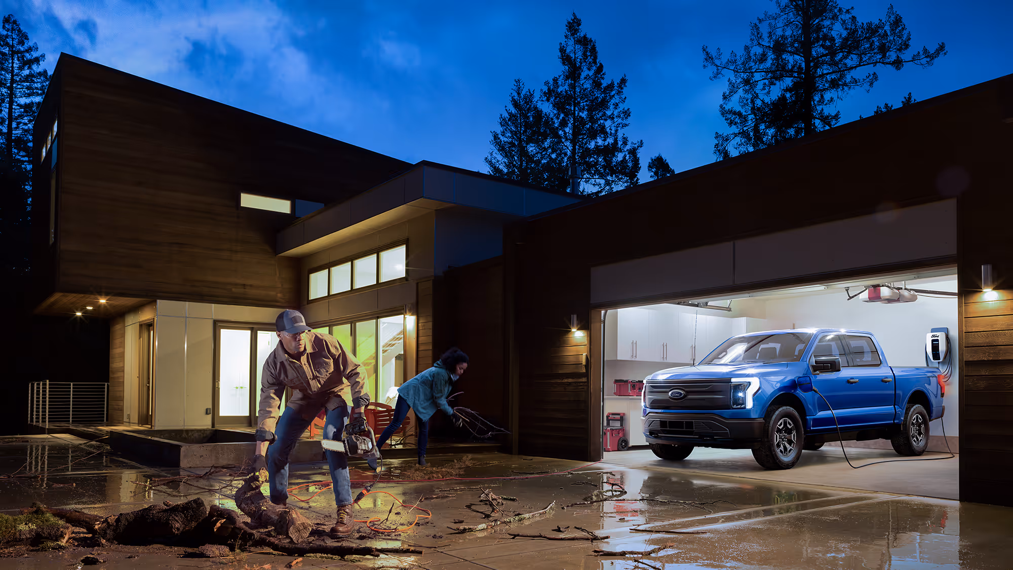 At dusk, a Ford F-150 Lightning sits in a modern driveway, warm house light spilling into the scene.