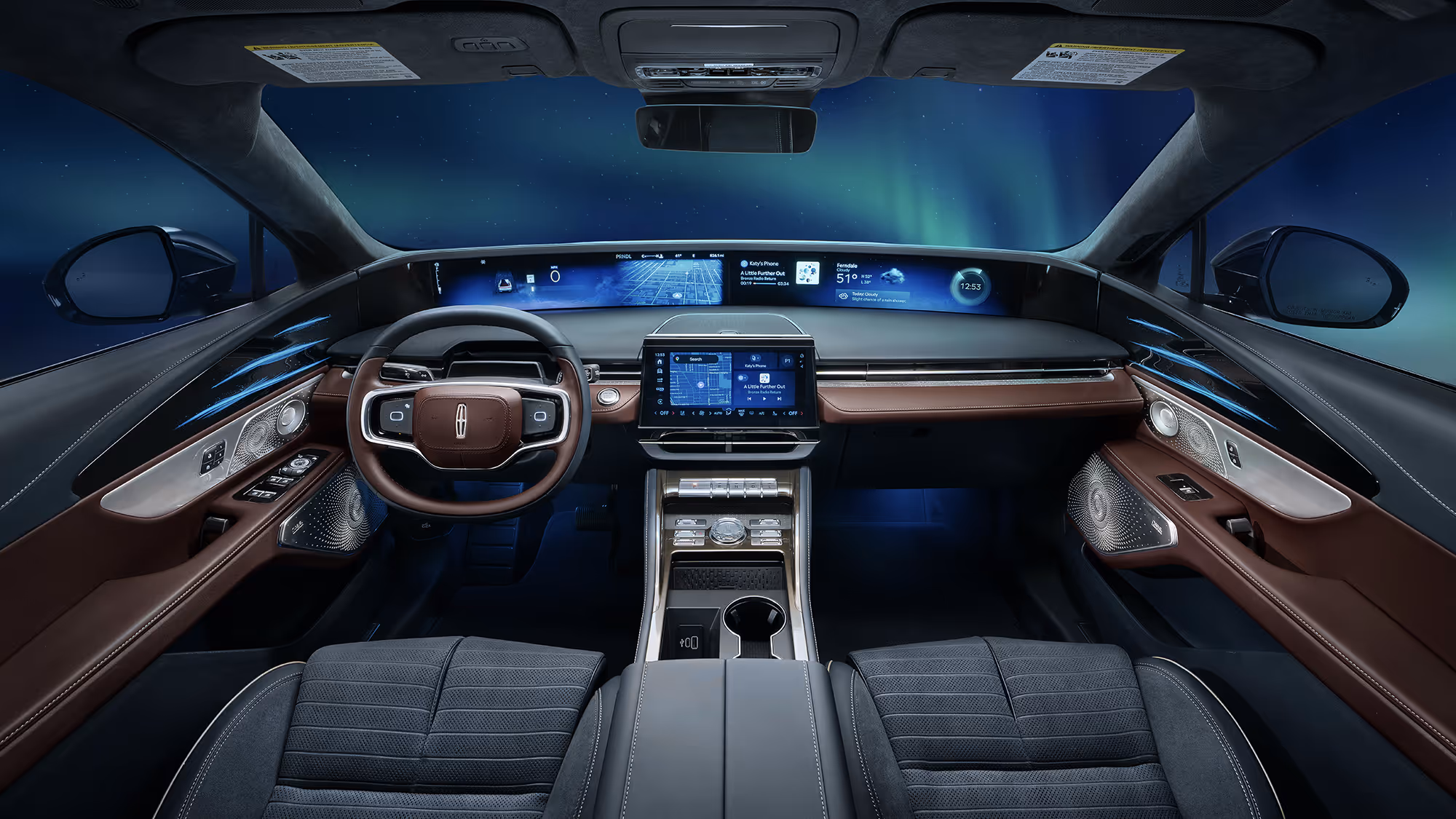 Driver’s perspective of a modern luxury interior with full-width digital screens and ambient lighting, northern lights visible outside