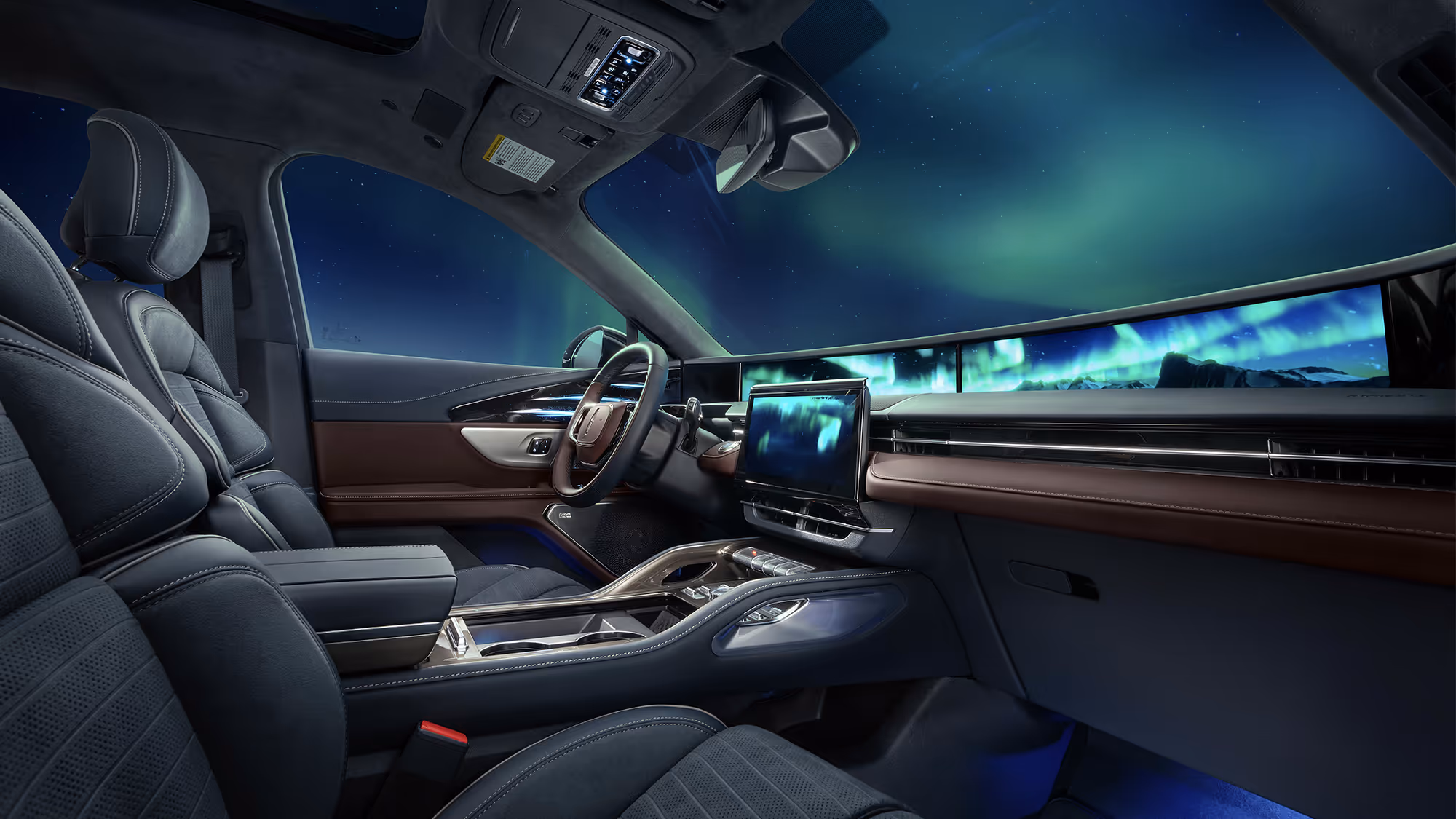Wide interior view of a luxury SUV with panoramic digital display and aurora borealis stretching across the dashboard and windshield