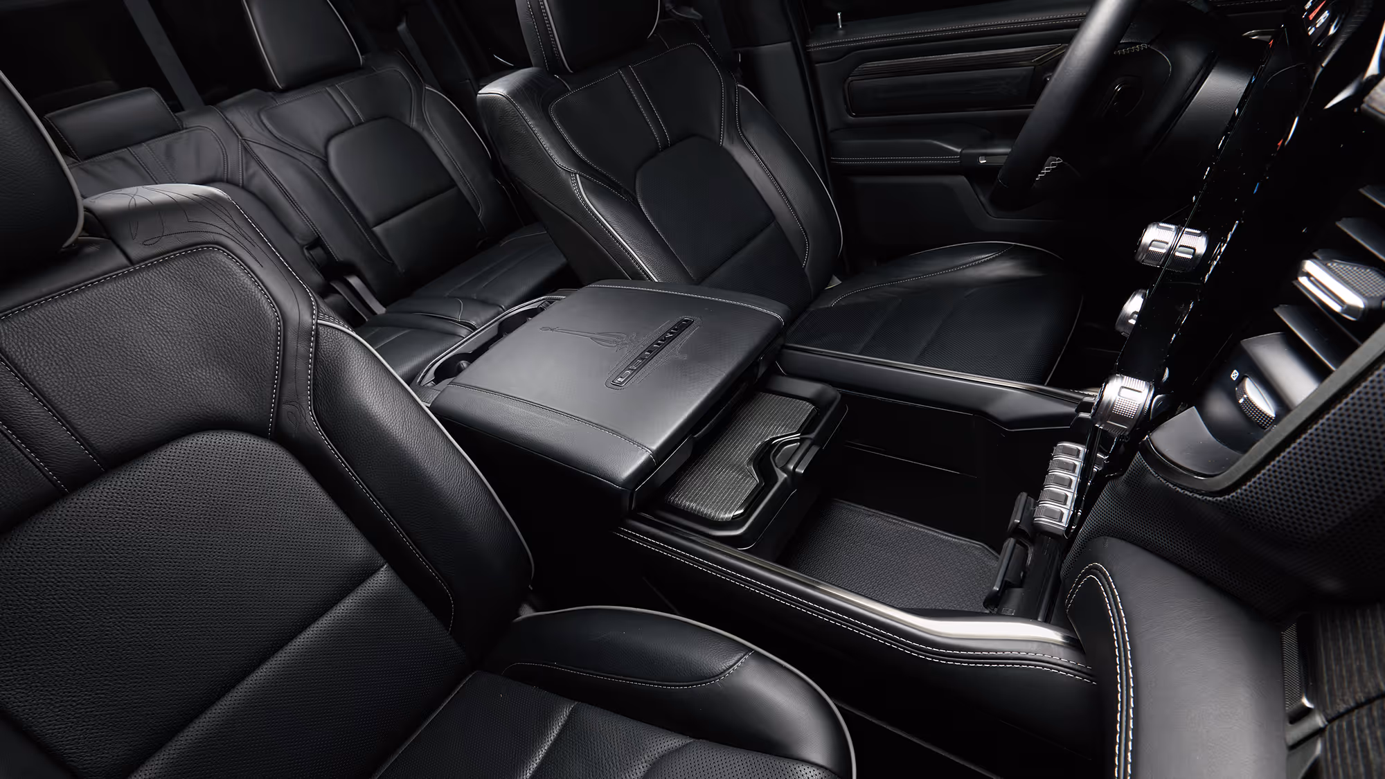 Premium truck interior with black leather seats and center console, emphasizing comfort, space, and refined detailing.