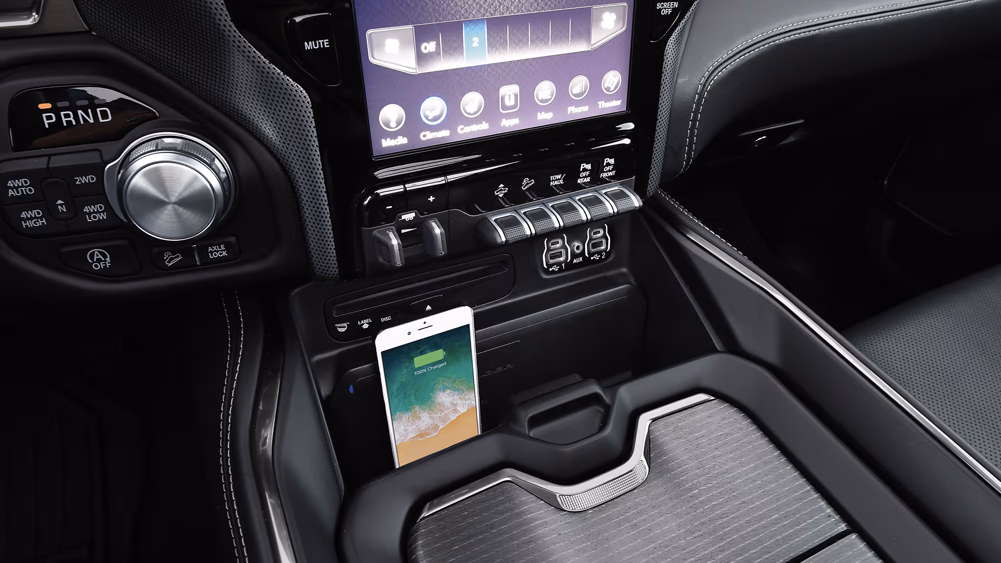 Center console with storage and charging area, featuring clean design and functional layout.