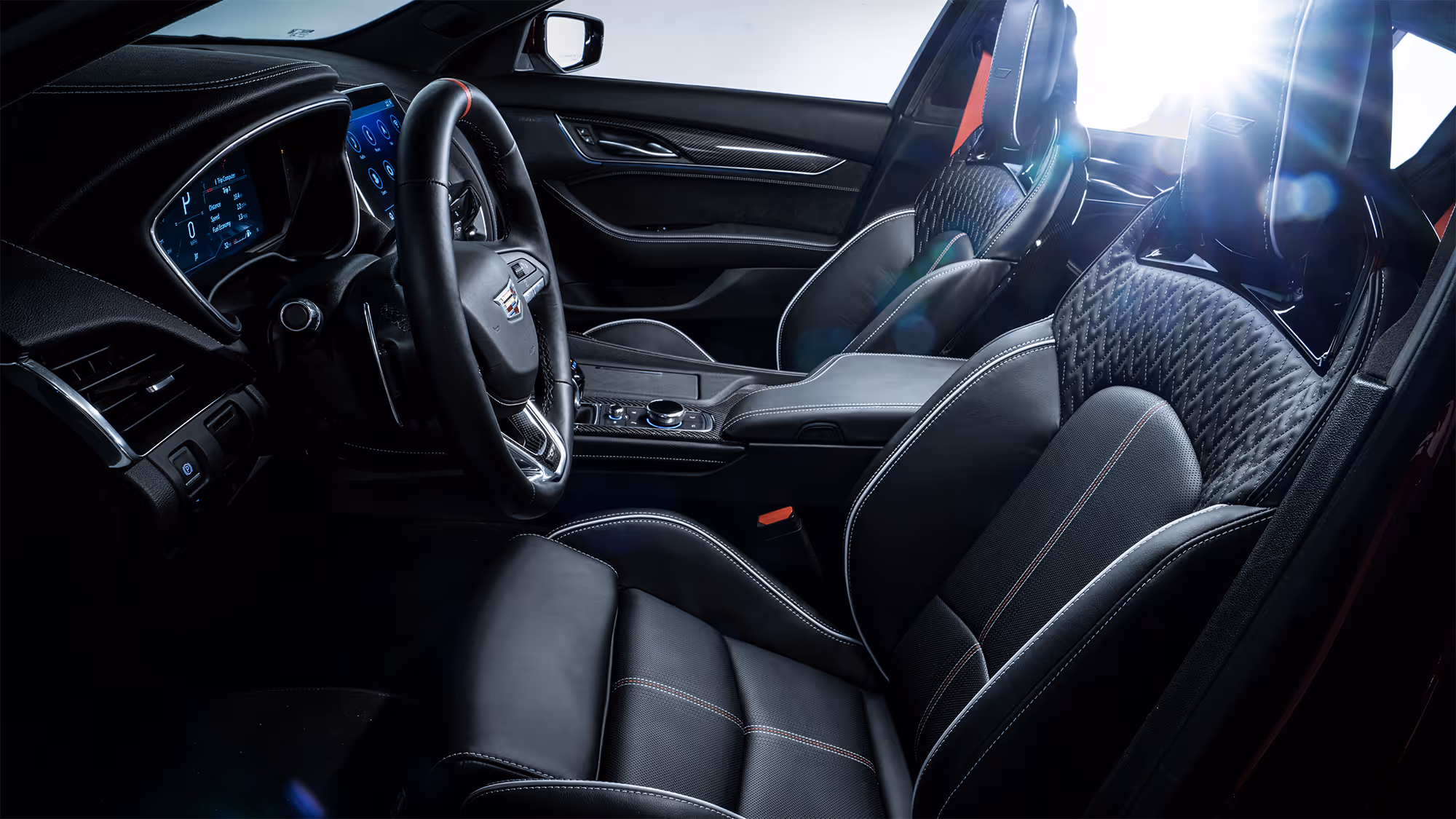 Cadillac Blackwing interior cockpit with black leather performance seats, carbon fiber trim, and digital instrument cluster.