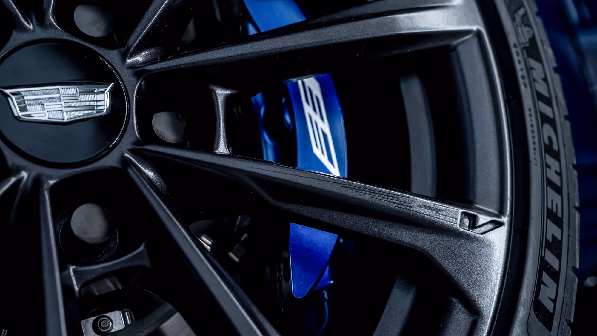 Wheel detail with Michelin tire branding and performance brake components visible.