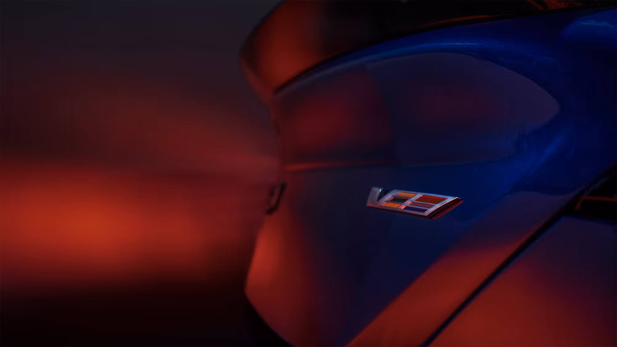 V-Series emblem on blue Cadillac Blackwing exterior with clean studio highlights.