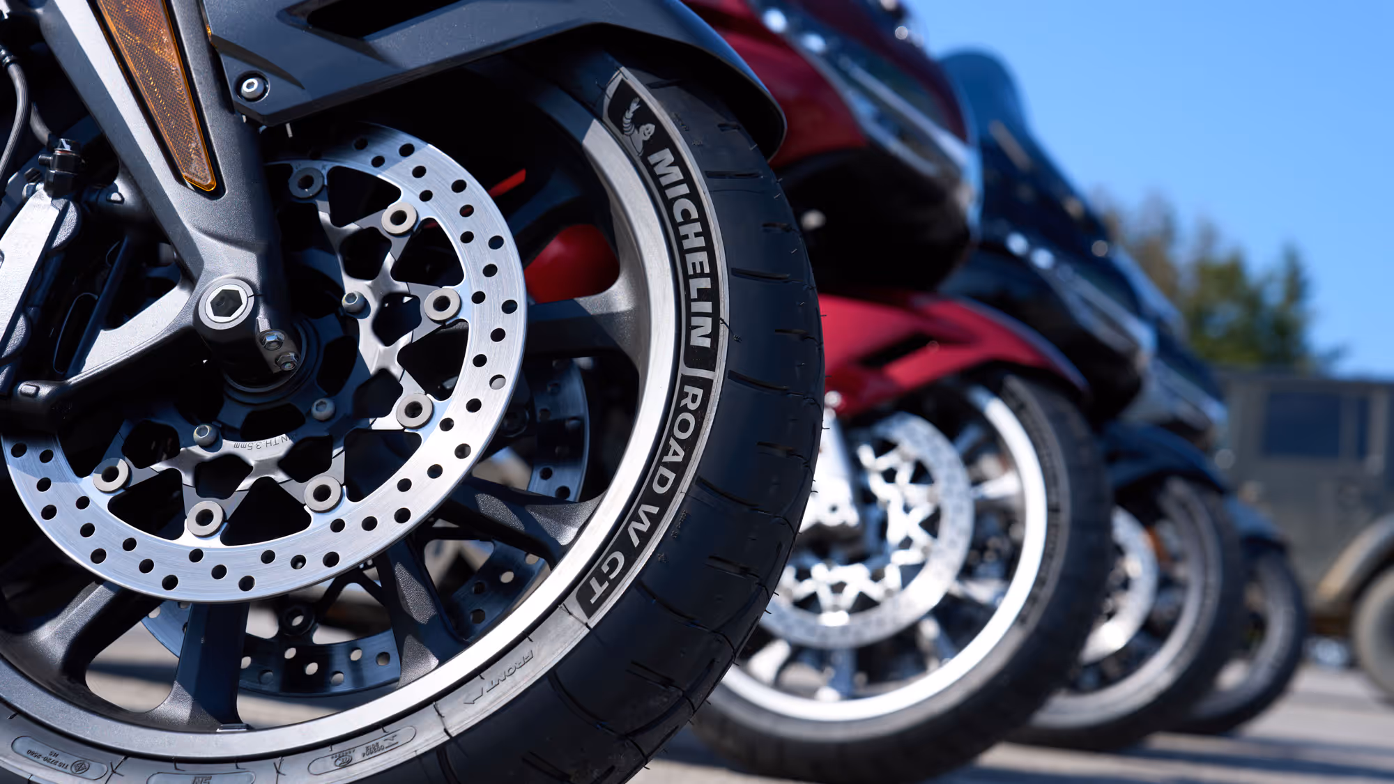 Close-up of Michelin Road GT tires and brake rotors lined up side by side