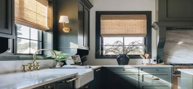 Woven wood shades in a kitchen with dark cabinets