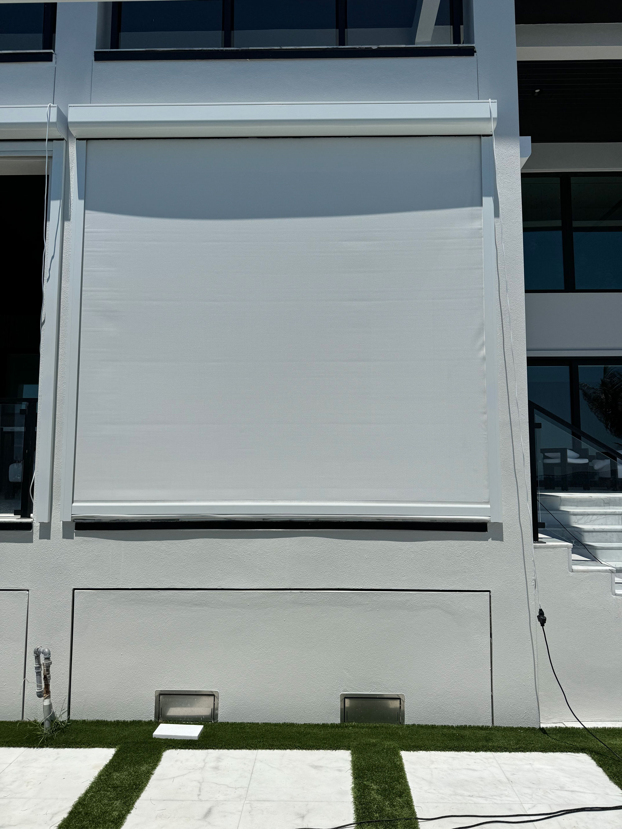 Motorized patio screen installed by West Shore Shade