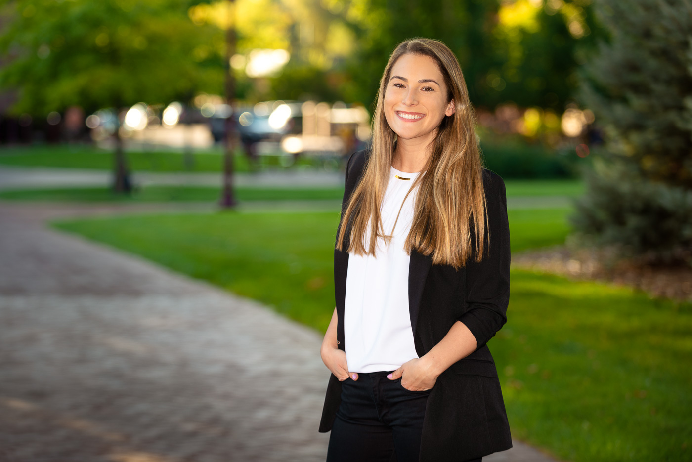A picture of Dr. Stephanie Chassman smiling against a lush natural background.