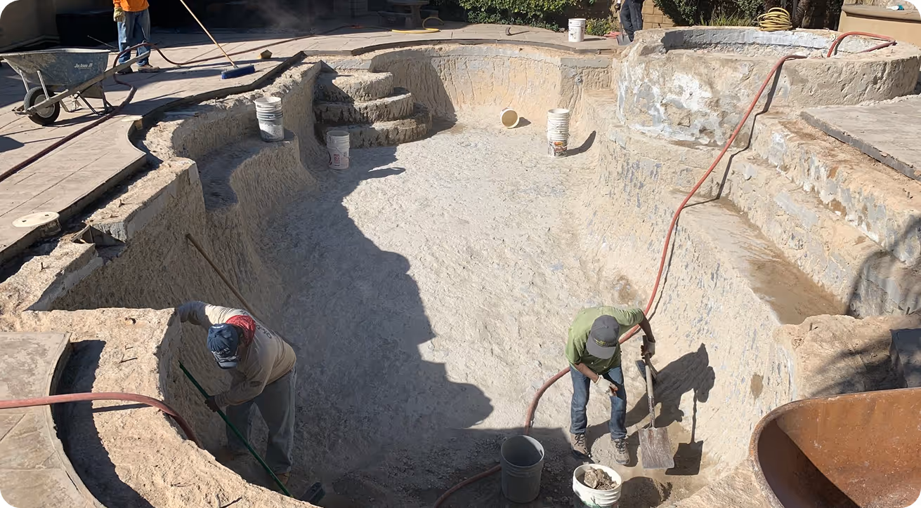 Construction workers digging and preparing foundation in concrete excavation site