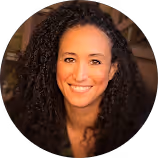 Smiling professional woman with curly hair in headshot portrait