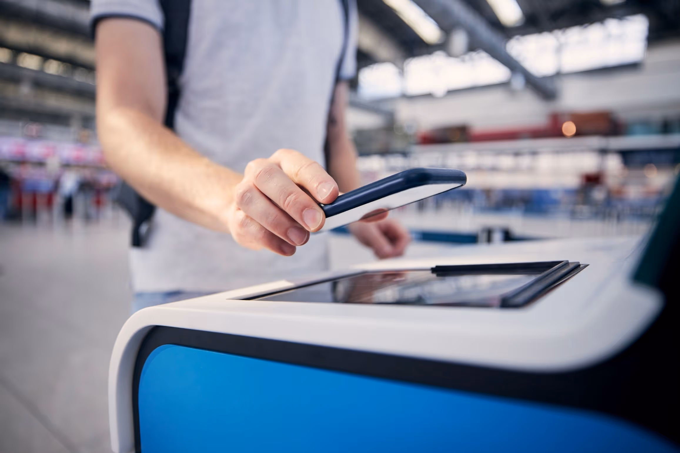 Man scanning his phone for boarding at airport