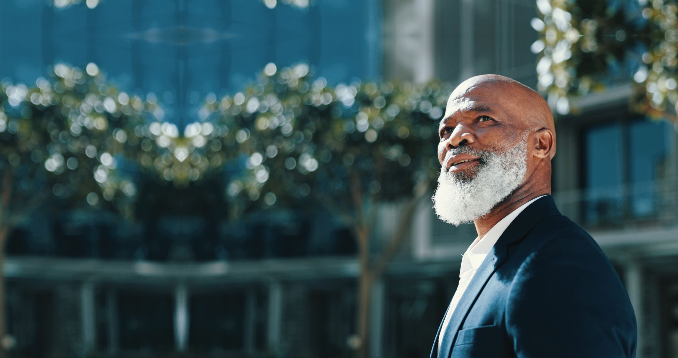 Older black man looking hopefully in the distance