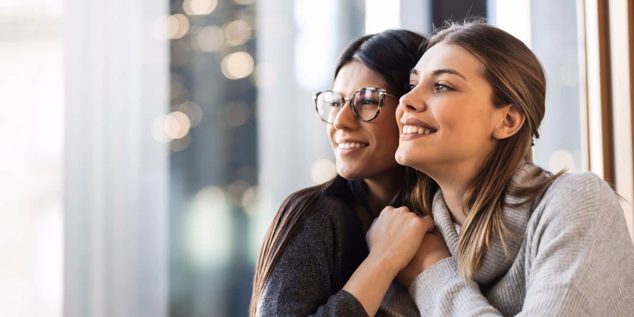 Two woman embracing and holding hands