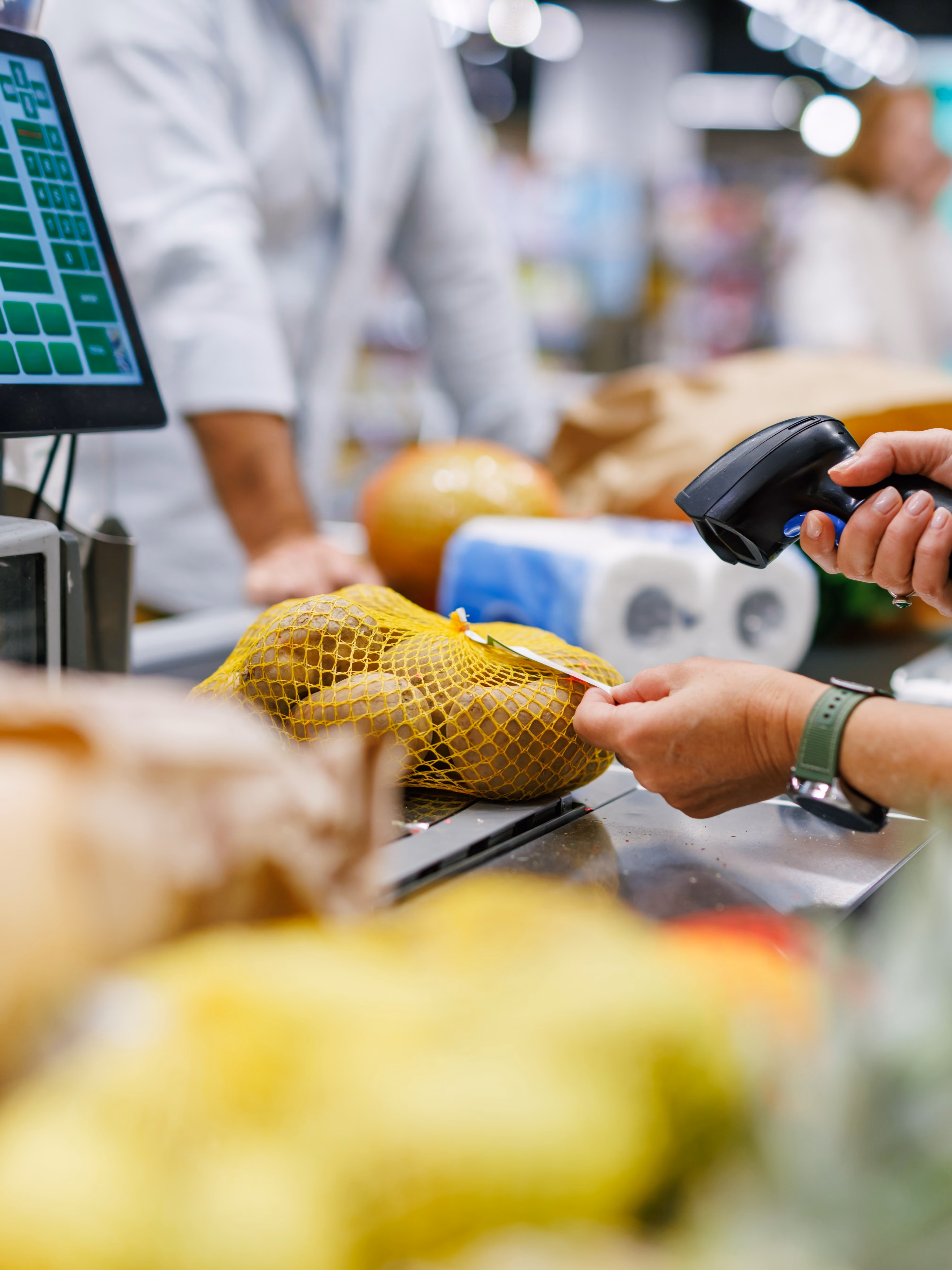 Cashier scanning products at checkout