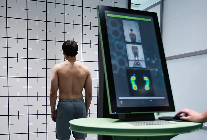 Чоловік проходить біомеханічний скринінг. Об'єктивні вимірювання постави та тиску стоп проводяться для виявлення прихованих проблем.