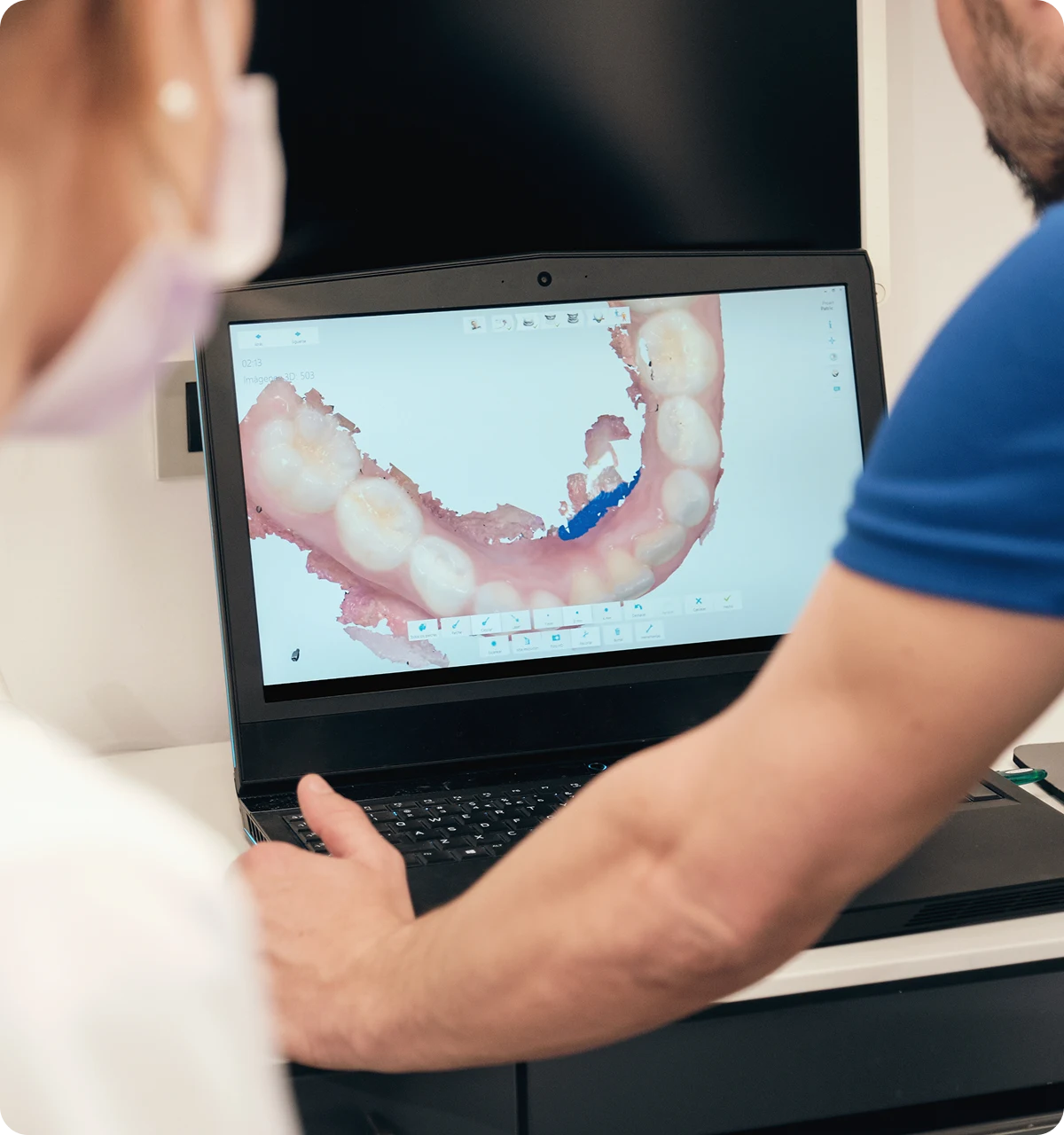 A dentist working with a laptop