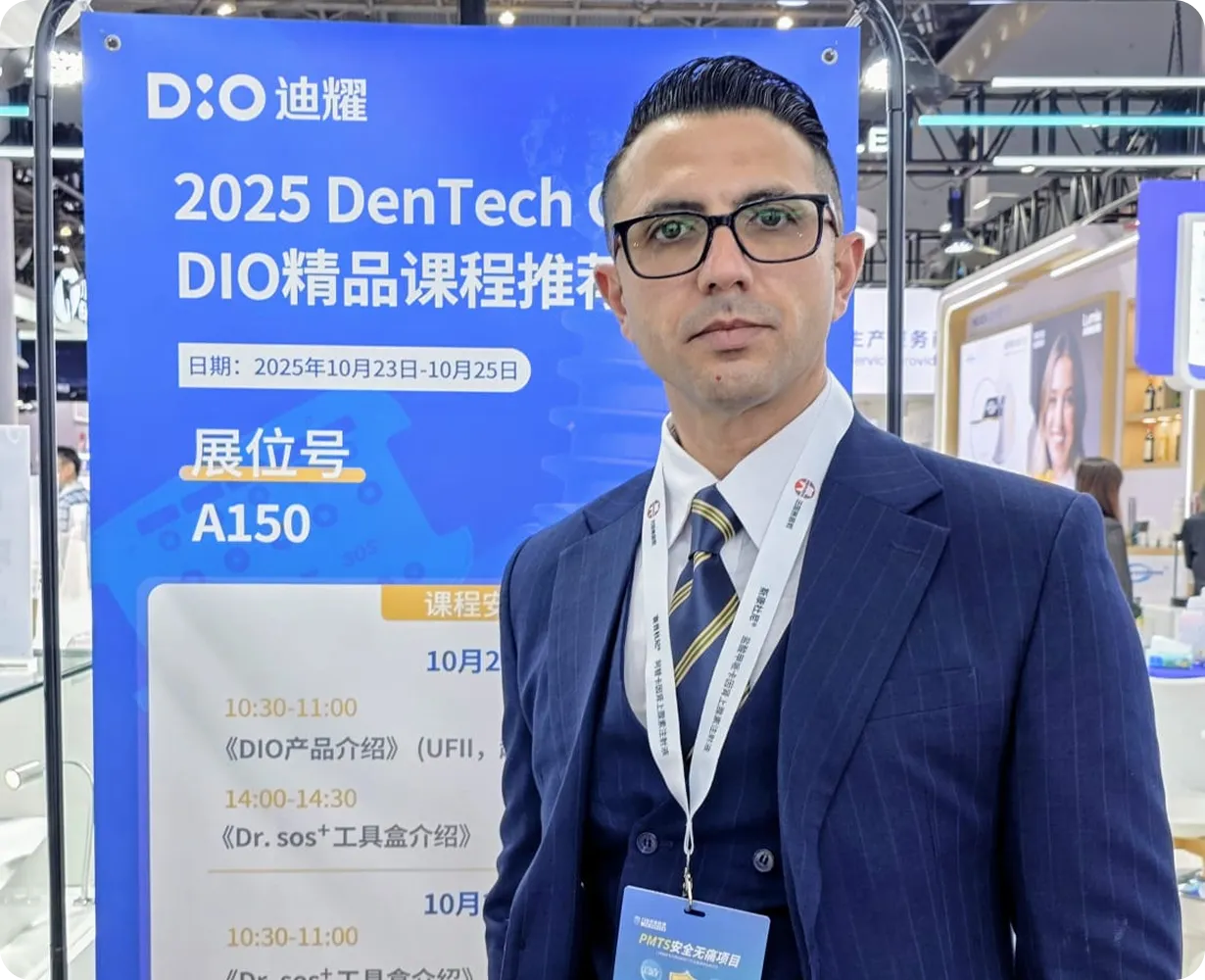 Man in glasses and a blue suit standing in front of a blue sign for the 2025 DenTech China DIO event with booth number A150.