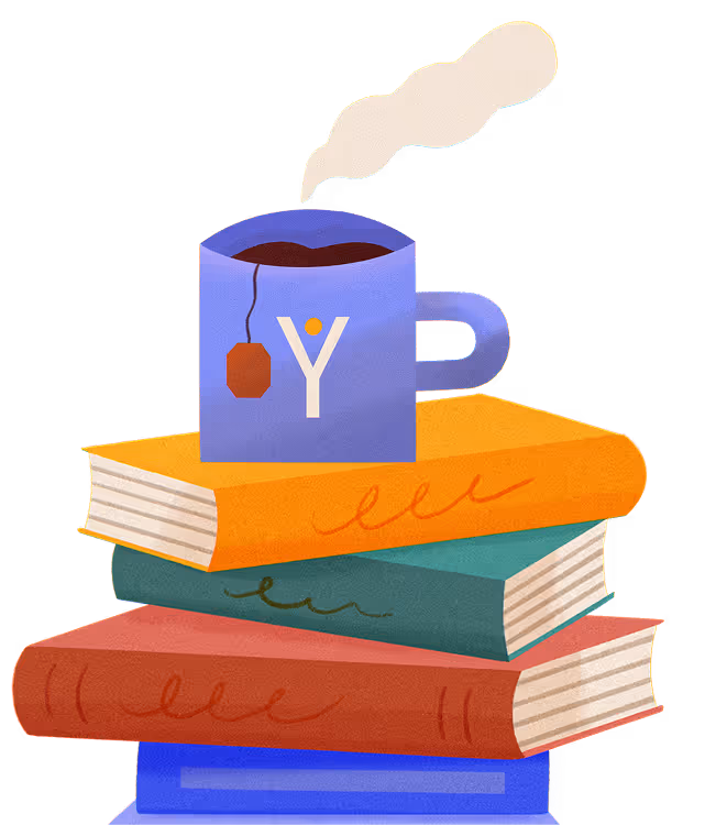 Blue tea cup with steaming hot tea and a tea bag on a stack of four colorful books.