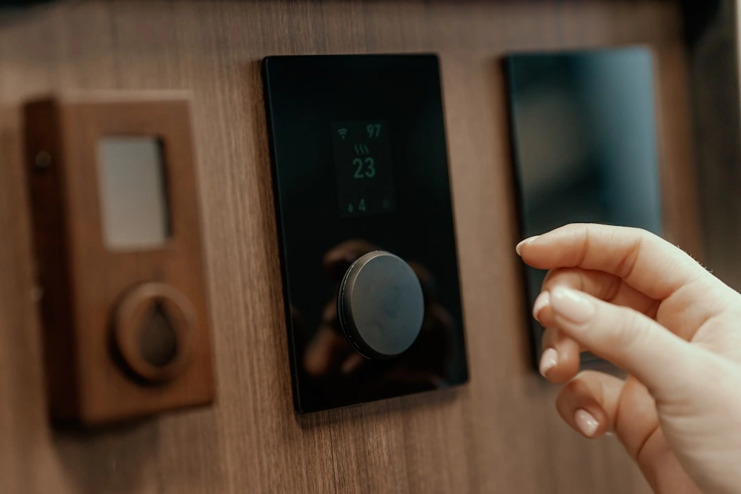Technician checking thermostat settings before seasonal HVAC maintenance