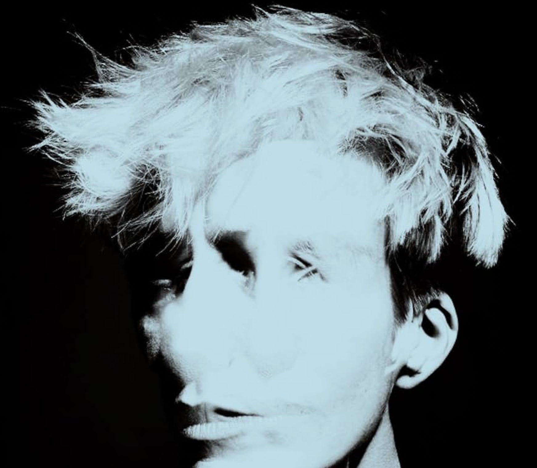 Black and white abstract portrait of Jeanne Added with multiple overlapping facial exposures and tousled hair against a dark background.