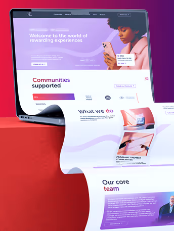 Laptop showing a rewards program webpage with a woman using a phone and sections on communities and team.