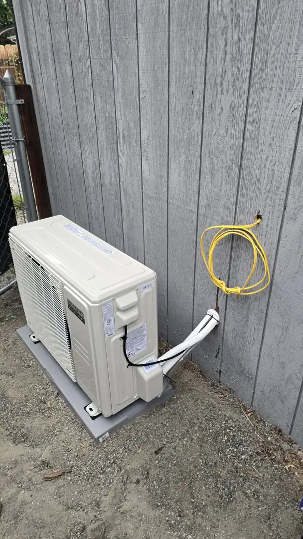 technician checking electrical components and tightening connections in an AC unit - spring ac tune up what to expect technician checking electrical components and tightening connections in an AC unit - spring ac tune up what to expect