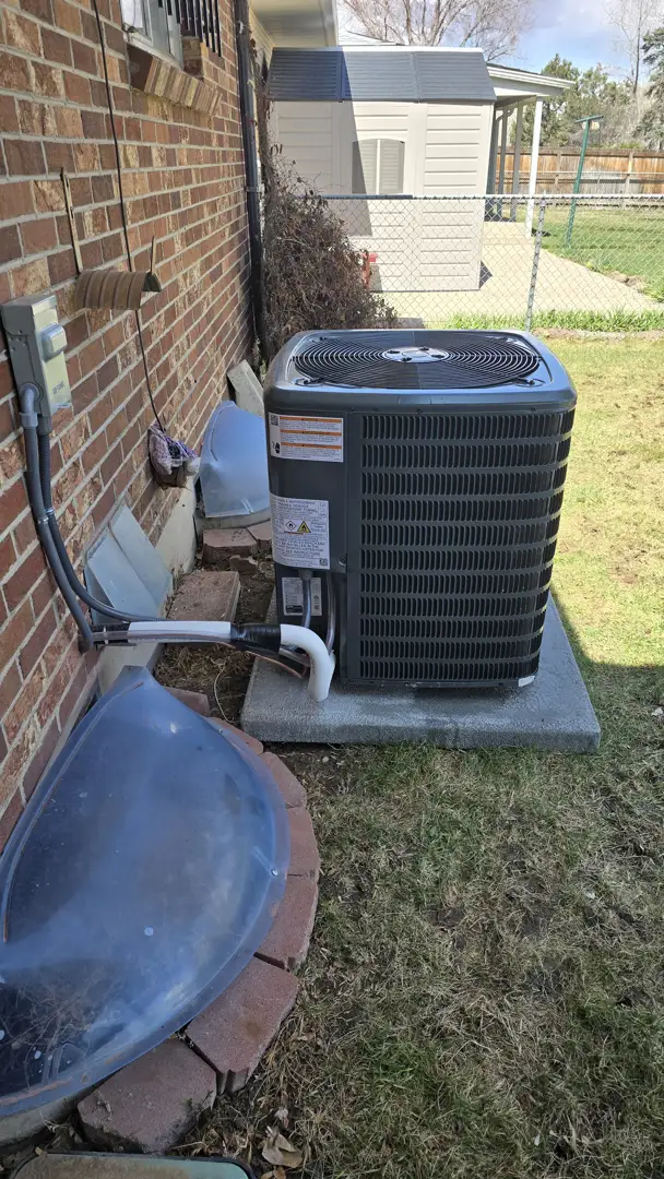 Clean high-efficiency outdoor AC unit in a residential backyard - is an hvac maintenance plan worth it