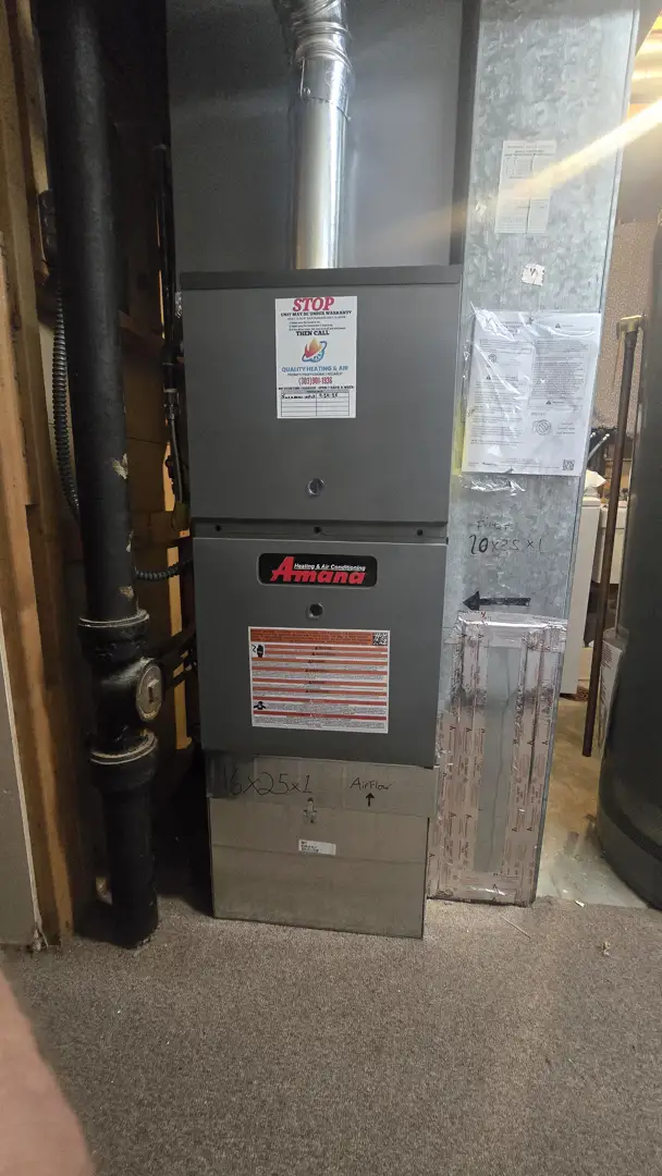 Homeowner replacing a pleated air filter in a furnace - hvac maintenance tips for homeowners Homeowner replacing a pleated air filter in a furnace - hvac maintenance tips for homeowners
