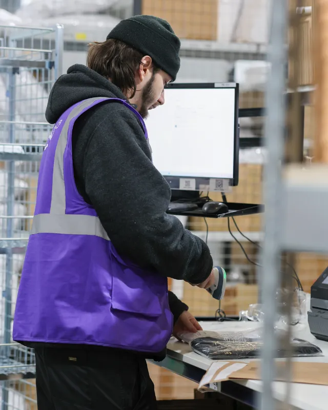 Man scanning products on pack bench