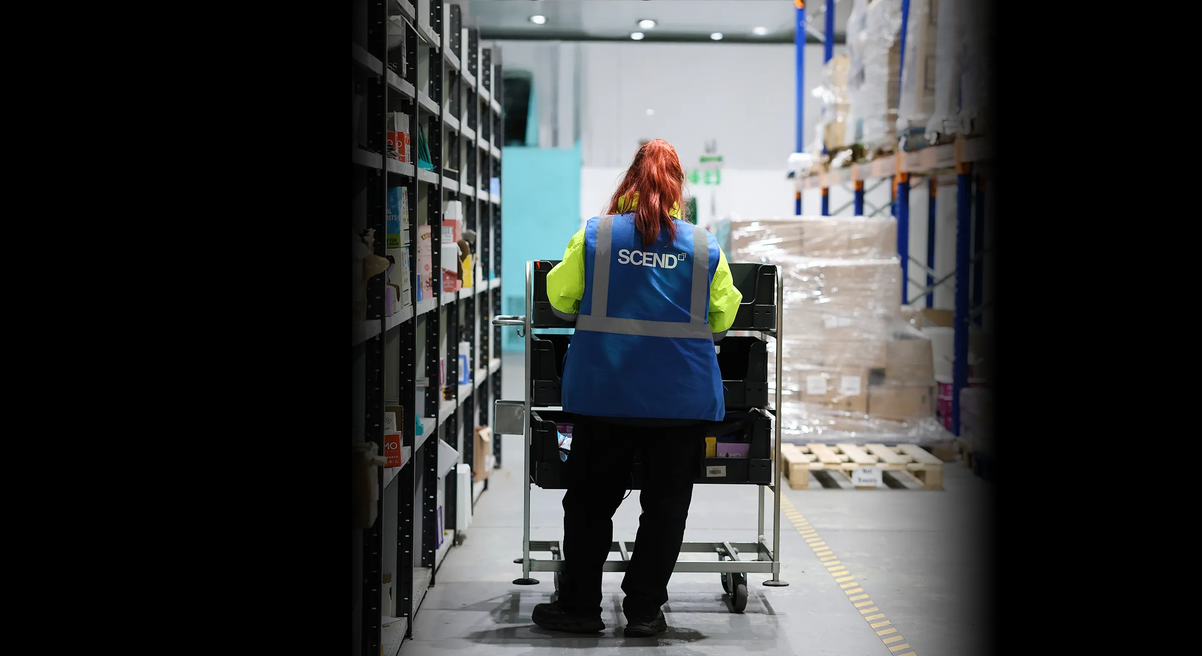 Woman pushing products in warehosue