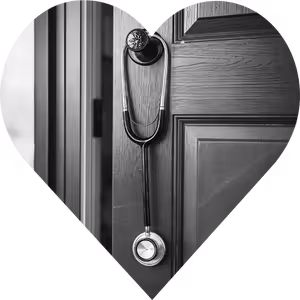 A heart shape with a stethoscope hanging from a front door with a monochrome background.