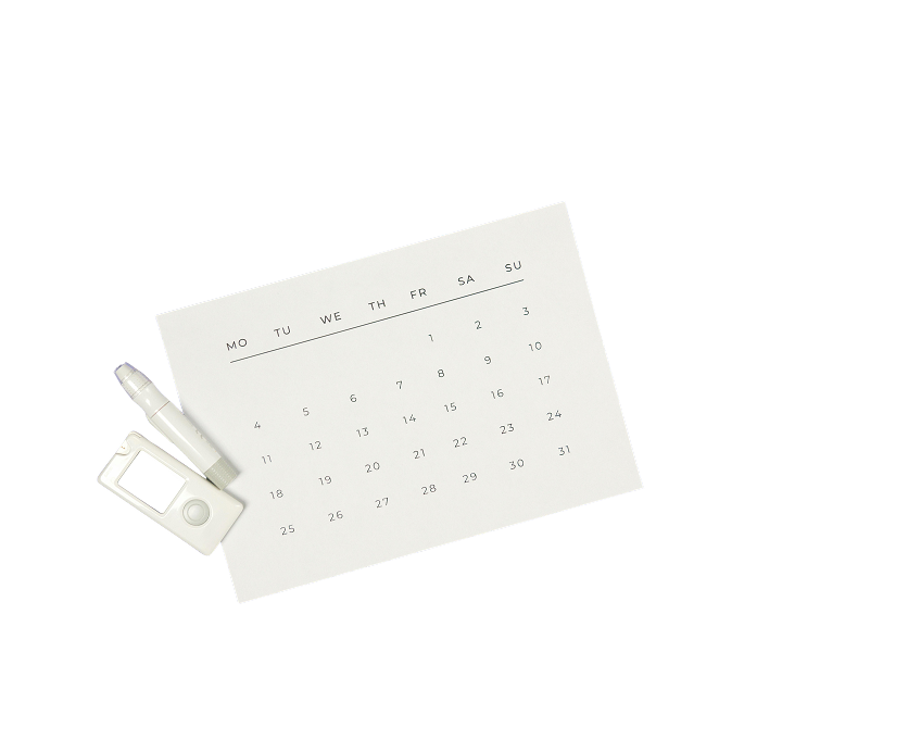 A calendar with diabetic care supplies next to it.