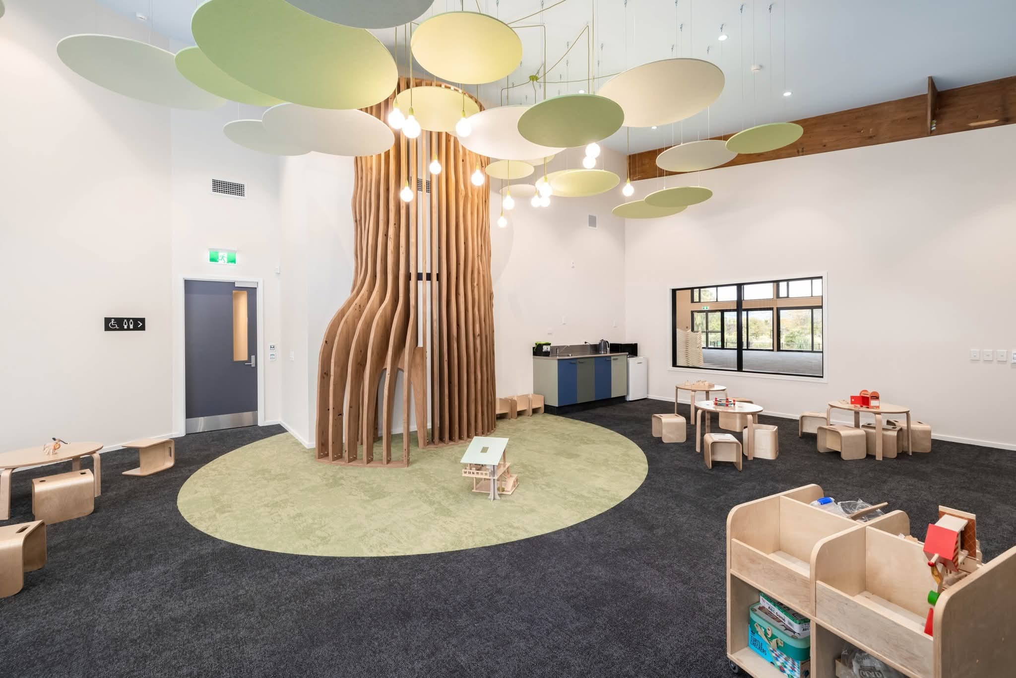 A children's space with feature tree and hanging 'leaves'