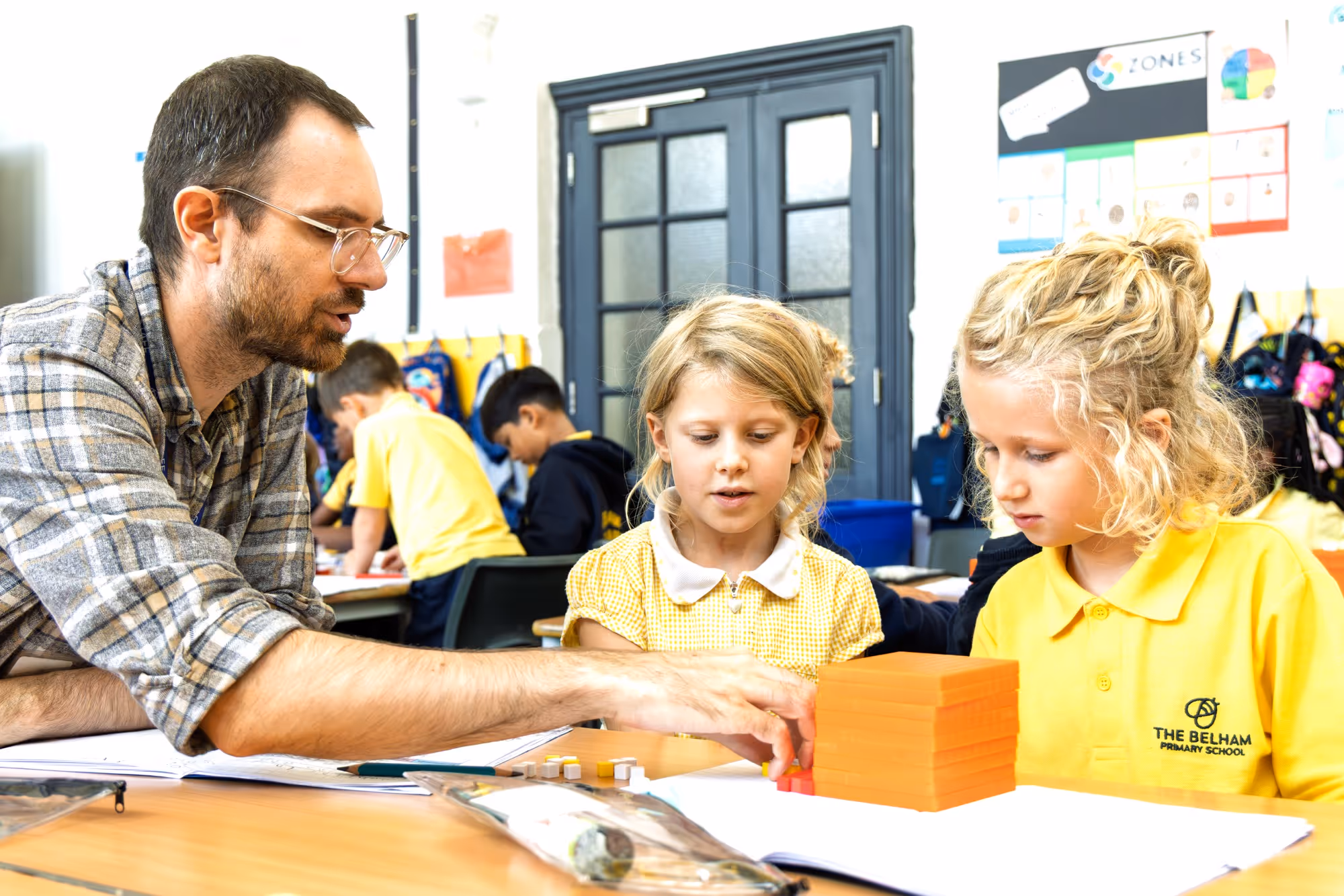 A teacher teaching two students