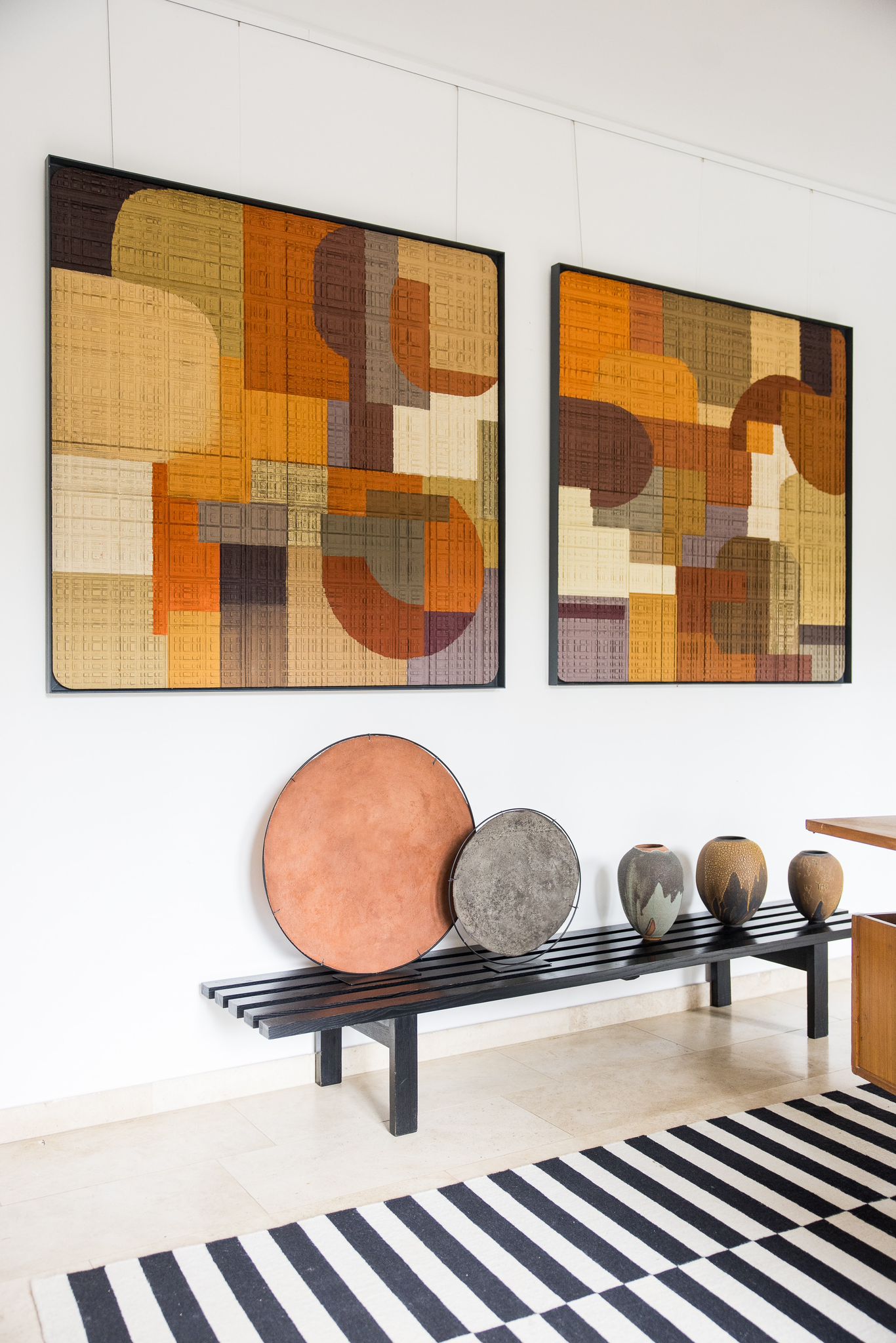 Two abstract geometric paintings on a warm wood panel, presented at Alexia Werrie Gallery, featuring interlocking angular forms that accentuate the grain.