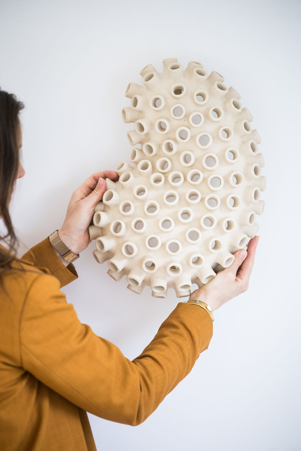 A striking wall-mounted ceramic sculpture inspired by the organic form of an octopus, handcrafted by Canadian artist Julie Bergeron. This piece merges marine imagery with sculptural abstraction, creating a tactile and visually captivating artwork.