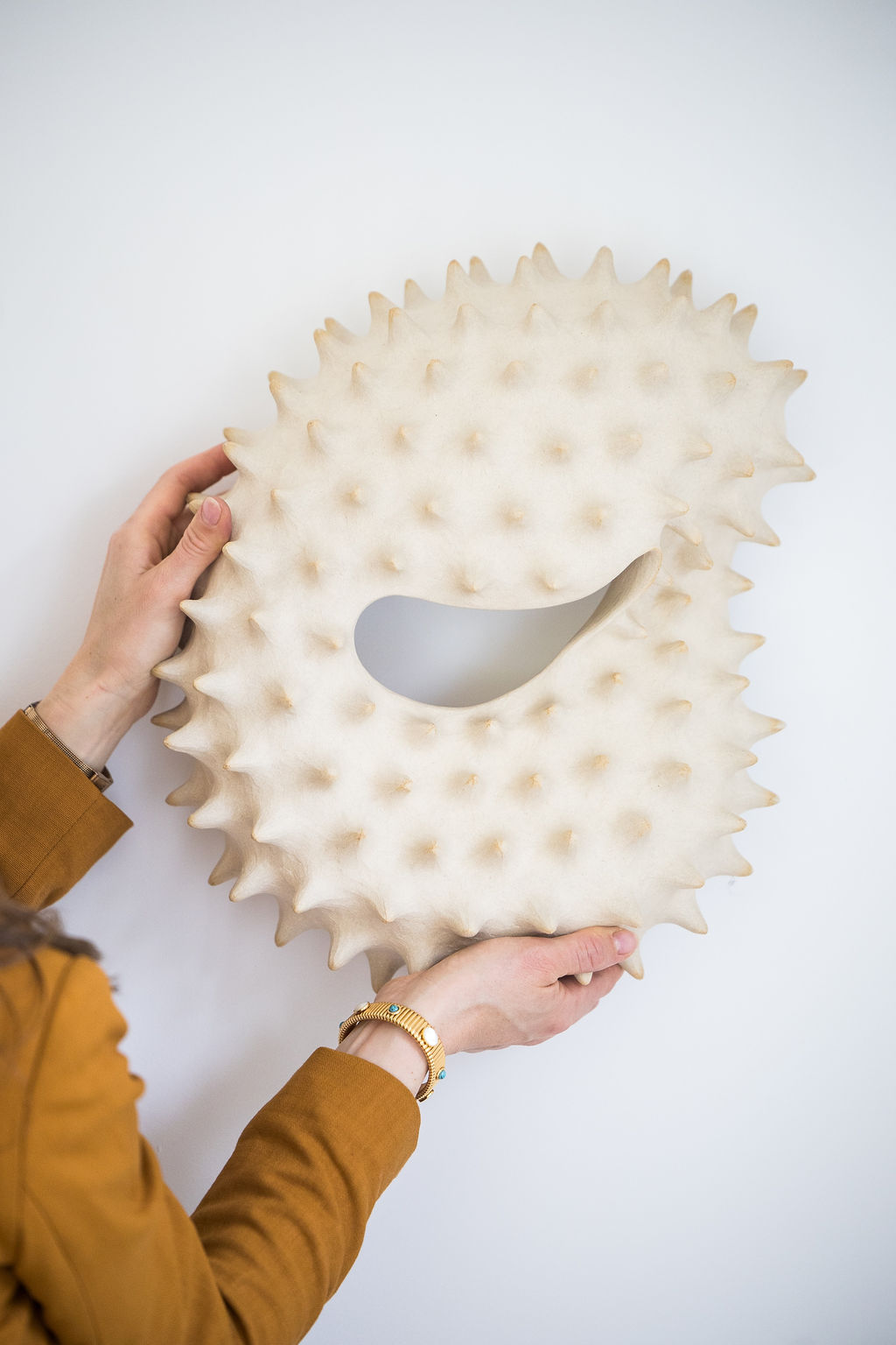 A striking wall-mounted ceramic sculpture handcrafted by Canadian artist Julie Bergeron. This piece merges marine imagery with sculptural abstraction, creating a tactile and visually captivating artwork.