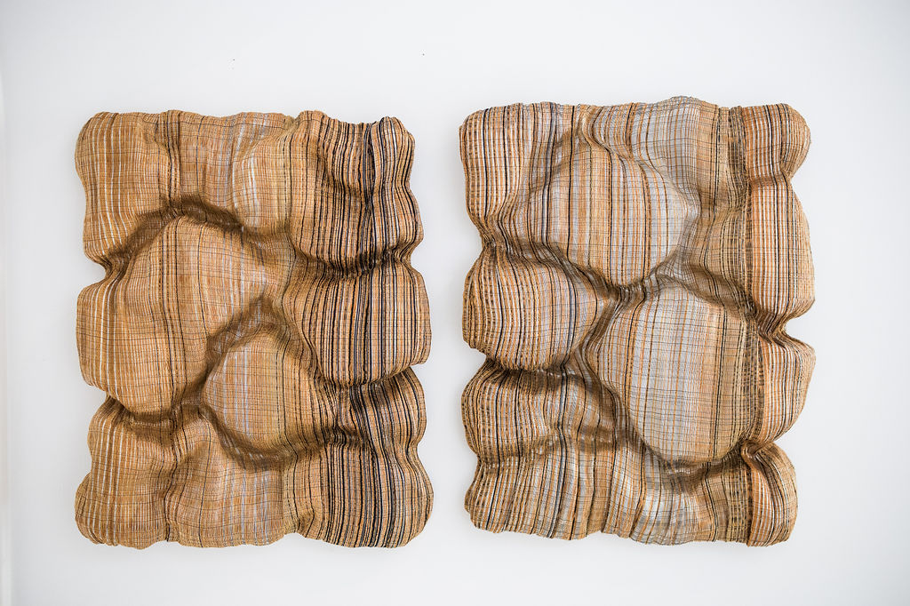 This diptych by Adeline Halot unfolds as a quiet dialogue between two panels, where material, rhythm, and tension meet. Working at the intersection of textile and sculpture, Halot transforms flax linen and fine metal threads into a tactile surface th