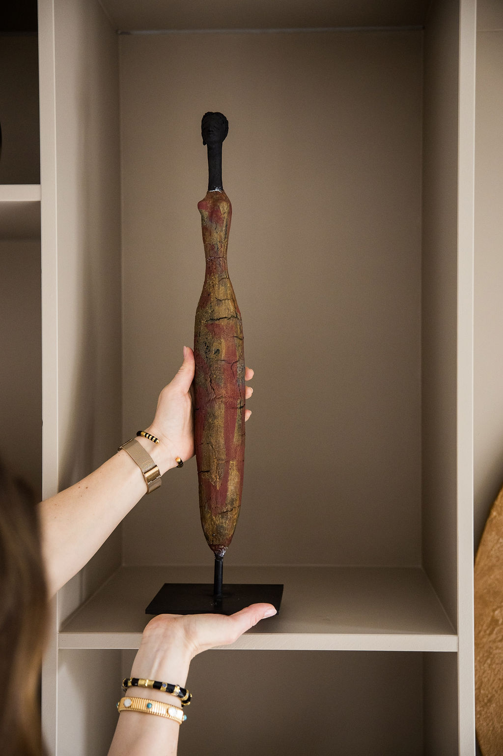 Bronze Woman sculpture (Terracotta Red) by Etiye Dimma Poulsen Characterised by the artist’s signature elongated proportions, the form rises with quiet elegance, its slender silhouette evoking a sense of resilience and introspection.