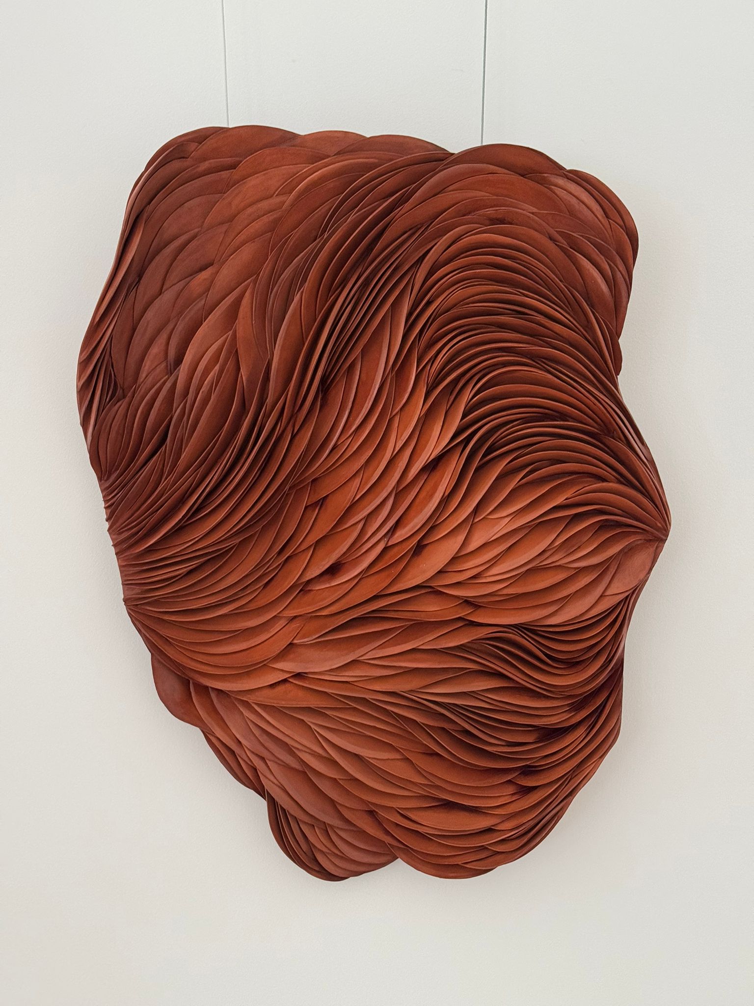 Ceramic mural composition by French artist Lorene Cavagna transforms the wall into a living surface.