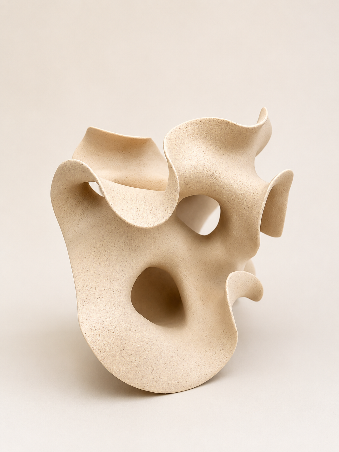 White Ceramic by belgian artist Liliane Demeester. The artist is fascinated by the plasticity of the clay. Perfectly manageable one moment, resisting the next . Always driven to turn the shape into a moving whole. 
