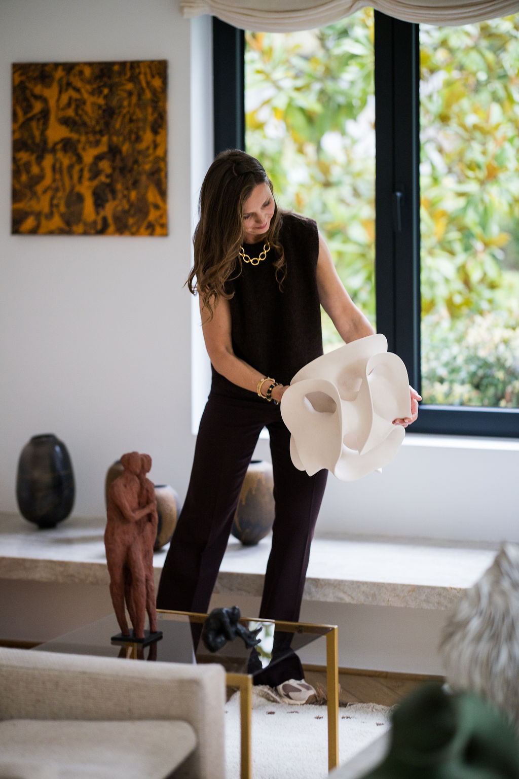 White organic ceramic sculpture by Liliane Demeester presented inside an elegant contemporary art-filled interior.