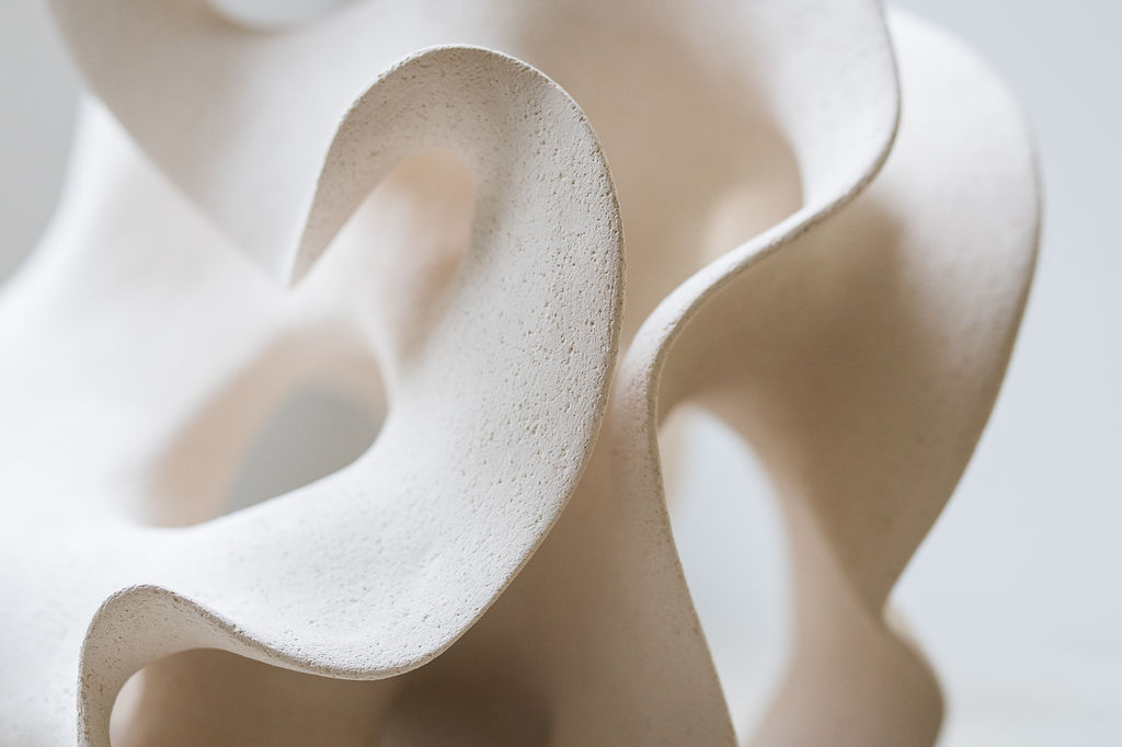 Close-up of a white ceramic sculpture by Belgian artist Liliane Demeester highlighting its delicate curves and matte texture.