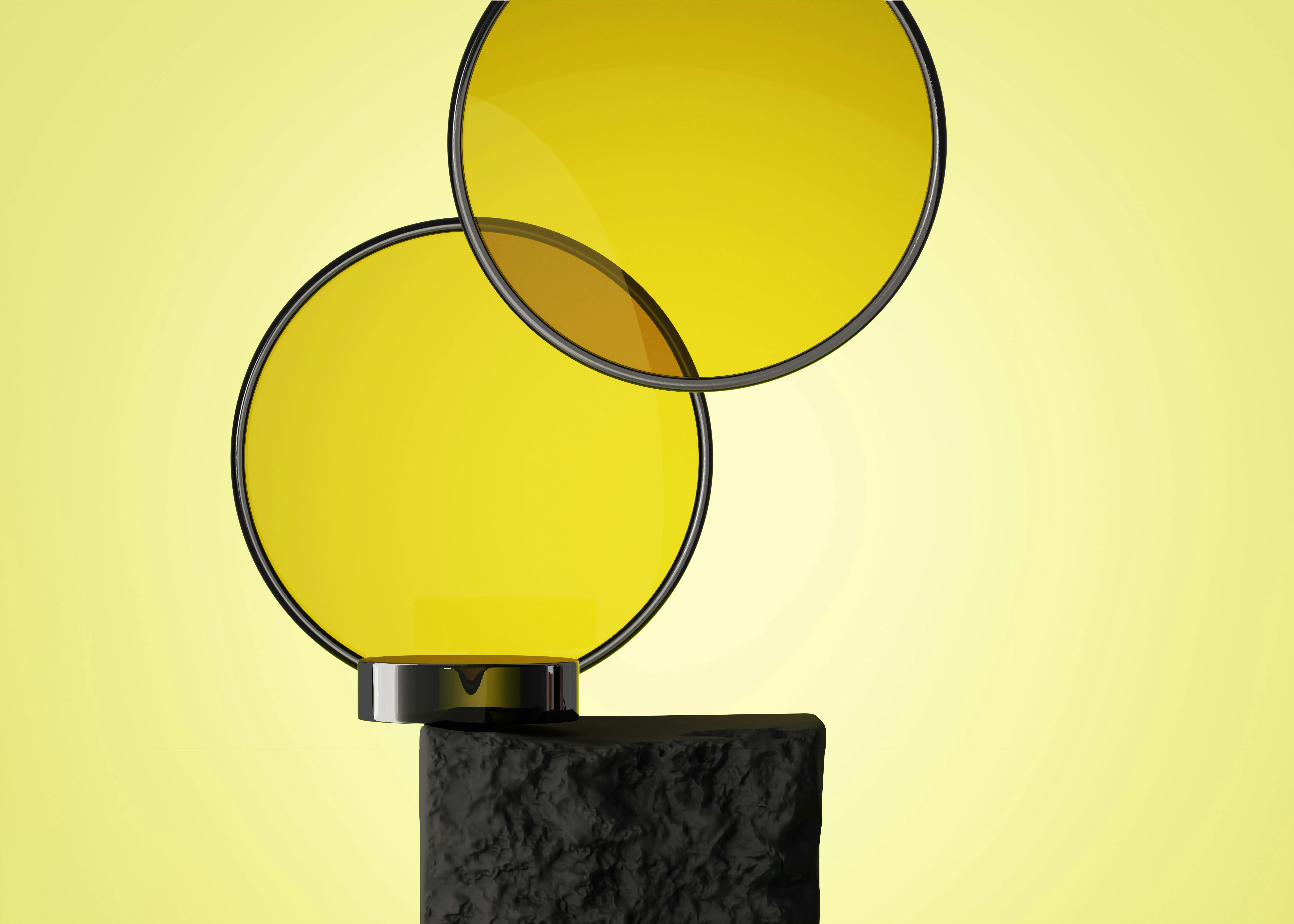Two overlapping yellow translucent circular filters with black rims on a textured black rectangular pedestal against a yellow background.