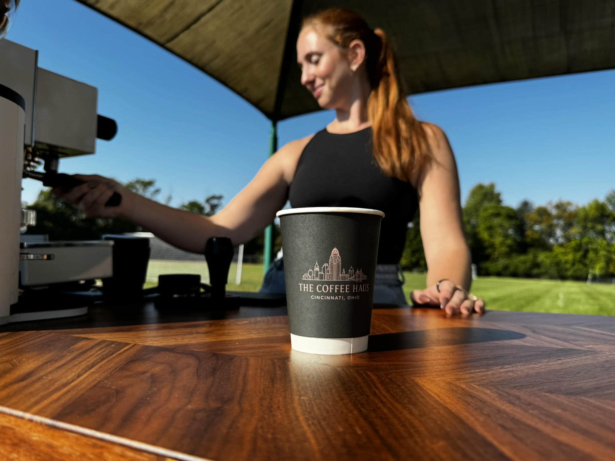 The Coffee Haus coffee cup served, waiting for customer pickup on top of coffee cart.