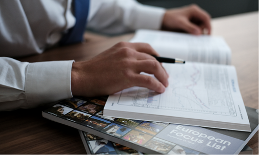 Close up image of someone marking up the WON Focus List printed book.